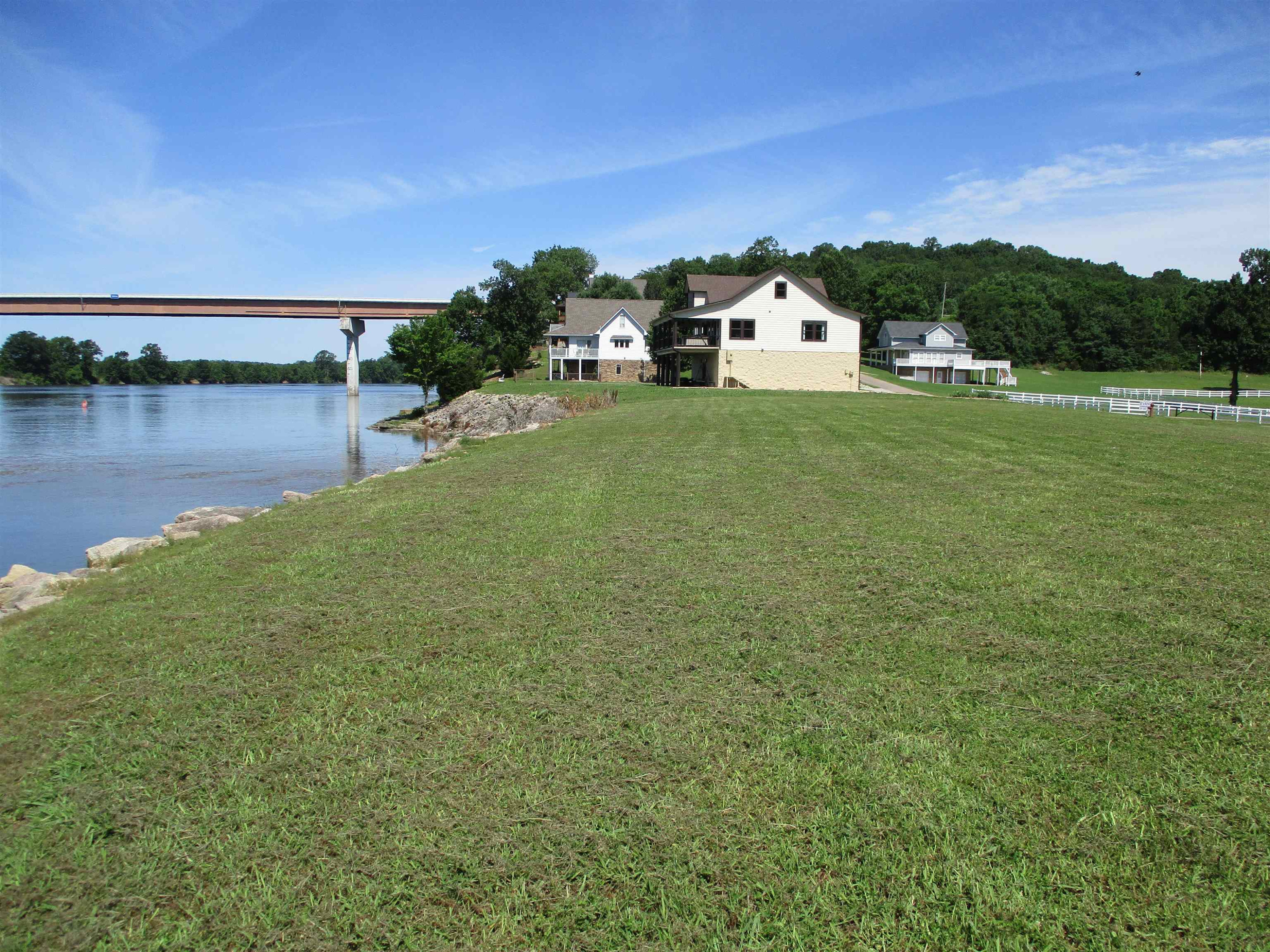 Lot 11 Riverstone Loop Bath Springs, TN 38311 - Photo 12 of 12 a view of a white house with a yard and lake view
