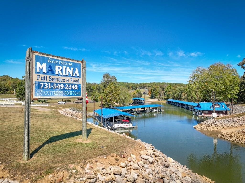 Lot 11 Riverstone Loop Bath Springs, TN 38311 - Photo 8 of 12 a view of a lake with a house in the background