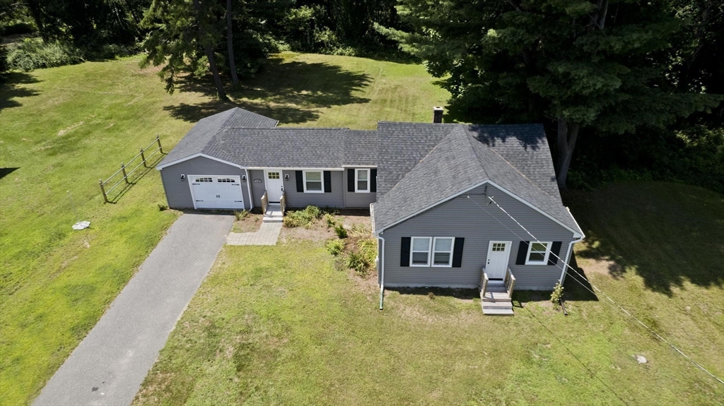a aerial view of residential houses with yard