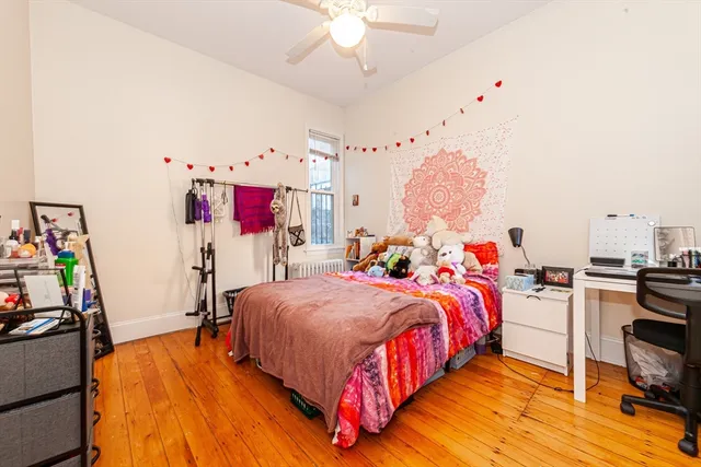 a bedroom with bed and a chandelier