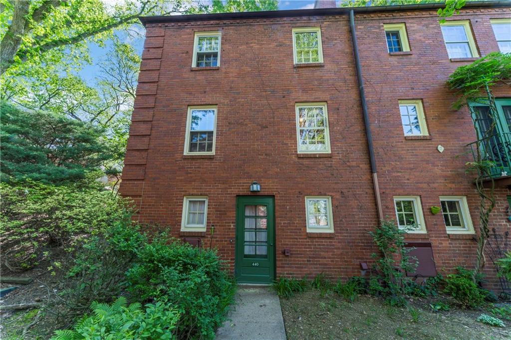 440 Olympia Road Pittsburgh, PA 15211 - Photo 20 of 25 front view of brick house with a yard