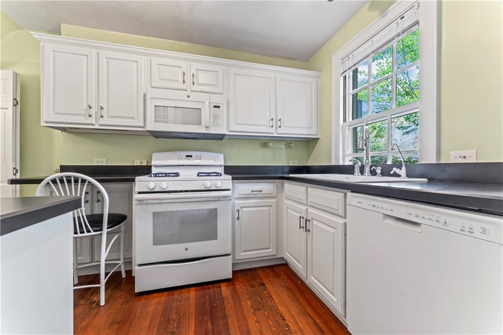 440 Olympia Road Pittsburgh, PA 15211 - Photo 8 of 25 a kitchen with granite countertop white cabinets a sink a window and appliances