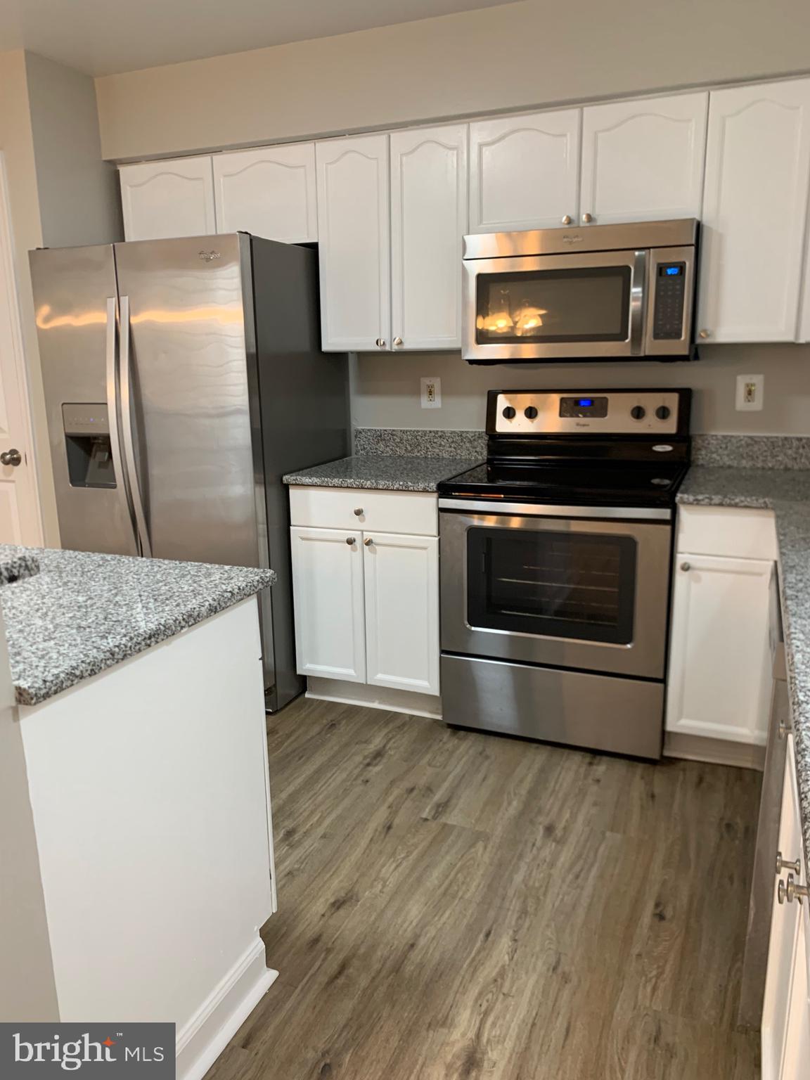 114 Sentry Ridge Smithsburg, MD 21783 - Photo 12 of 60 a kitchen with granite countertop a stove a microwave a refrigerator a sink and cabinets