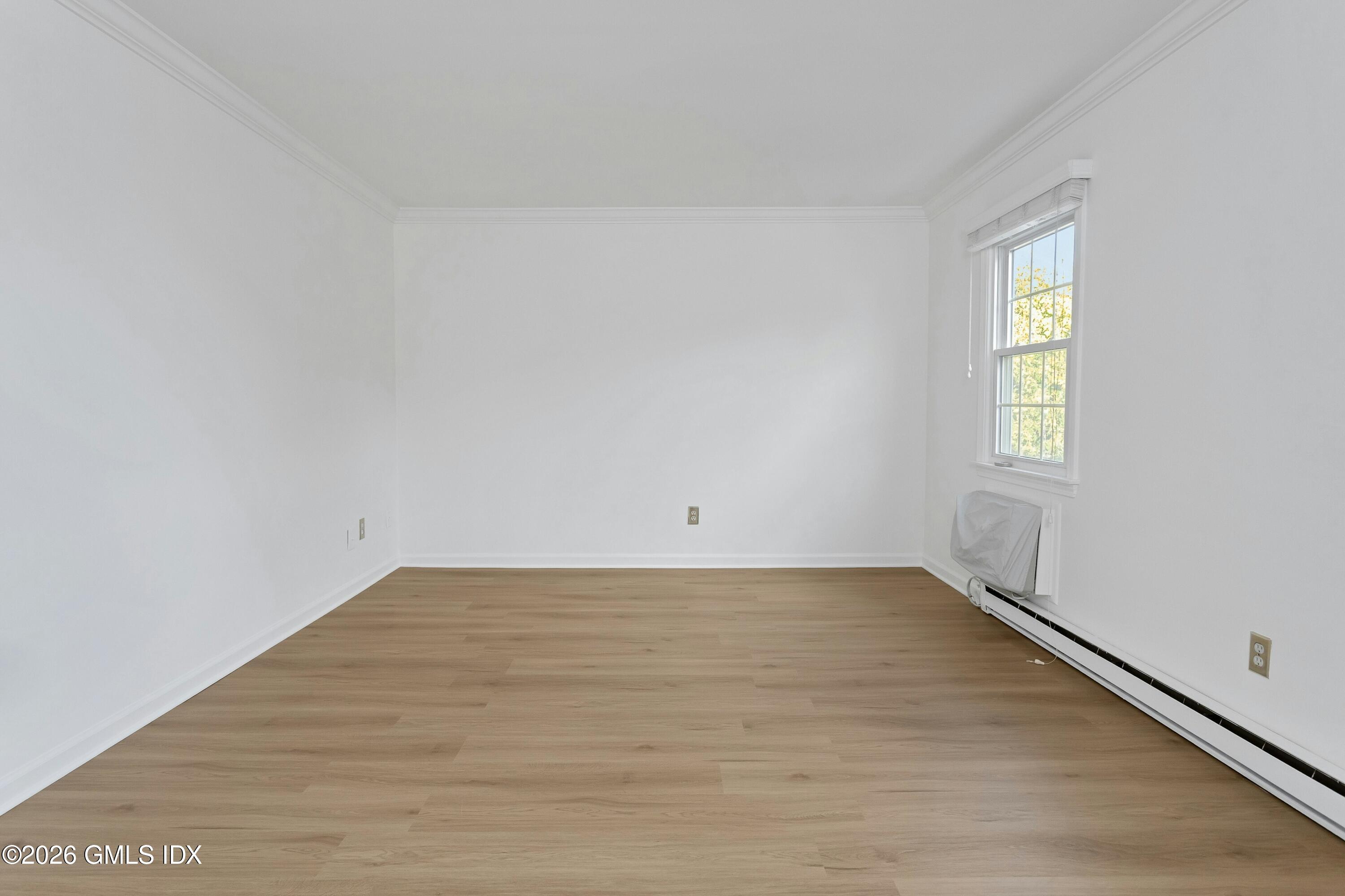 9 Weaver Street, Unit 9 Greenwich, CT 06831 - Photo 15 of 18 a view of an empty room with wooden floor and a window