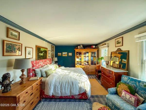 a bedroom with bed and wooden floor