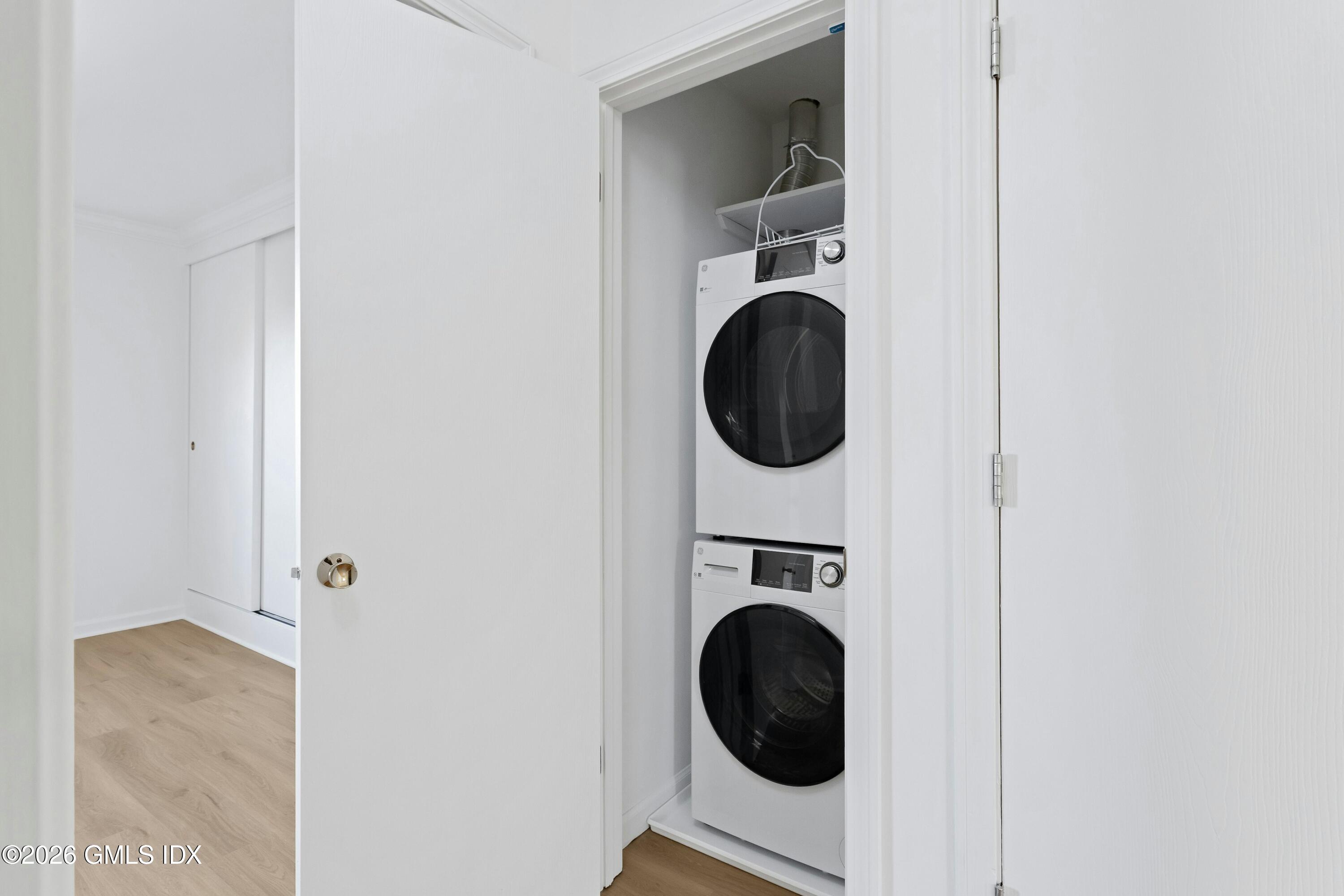 9 Weaver Street, Unit 9 Greenwich, CT 06831 - Photo 9 of 18 a view of a hallway with washer and dryer