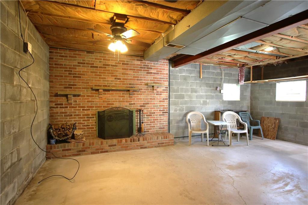 796 Rte 481 Monongahela, PA 15063 - Photo 3 of 26 Beautiful Brick Wood Burning Fireplace in MASSIVE 31x22 Game Room w/ Ceiling Fan Light, Glass Block Windows and Open Concept! (wall to left in Photo has a slight bow and price has been adjusted to reflect condition, being sold AS-IS!)