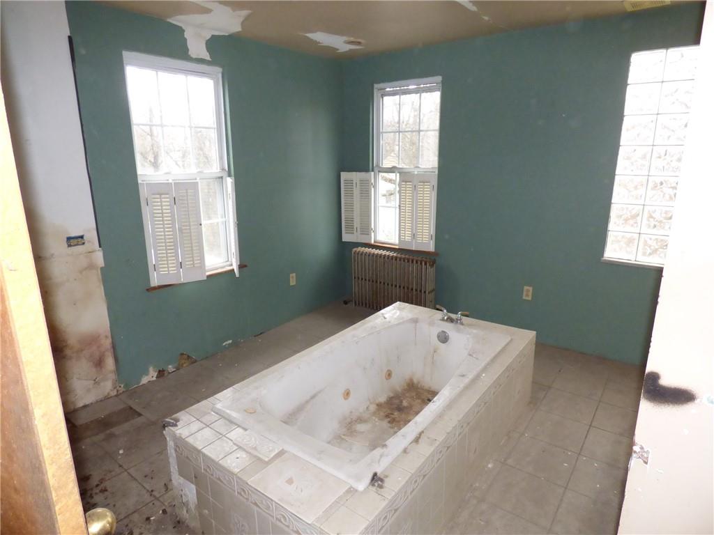 211 Amherst Street Pittsburgh, PA 15220 - Photo 29 of 40 a bath tub sitting in a bathroom next to a window