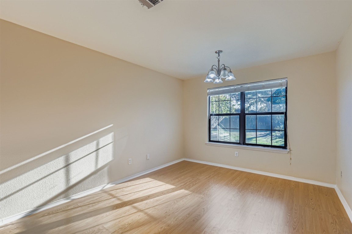 1105 American Robin Path Pflugerville, TX 78660 - Photo 12 of 32 wooden floor in an empty room with a window