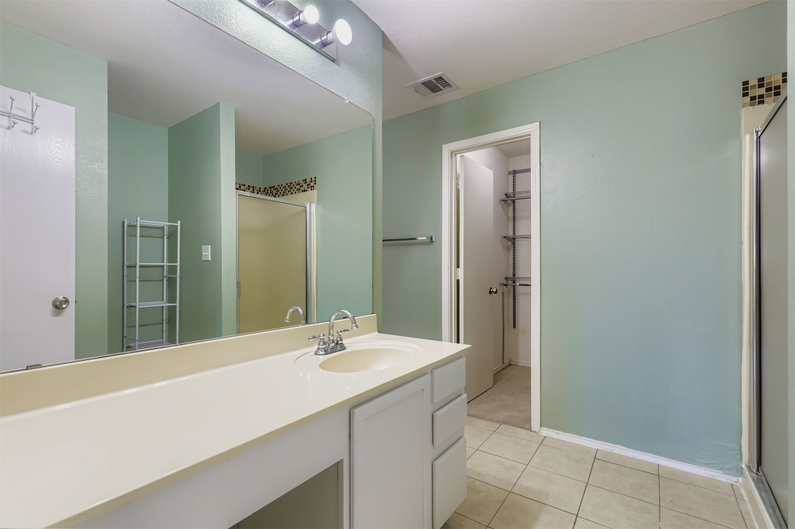 1105 American Robin Path Pflugerville, TX 78660 - Photo 16 of 32 a bathroom with a sink a toilet and shower