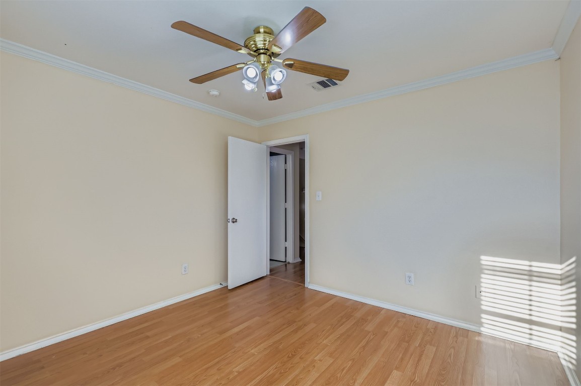 1105 American Robin Path Pflugerville, TX 78660 - Photo 19 of 32 an empty room with a window and a chandelier fan