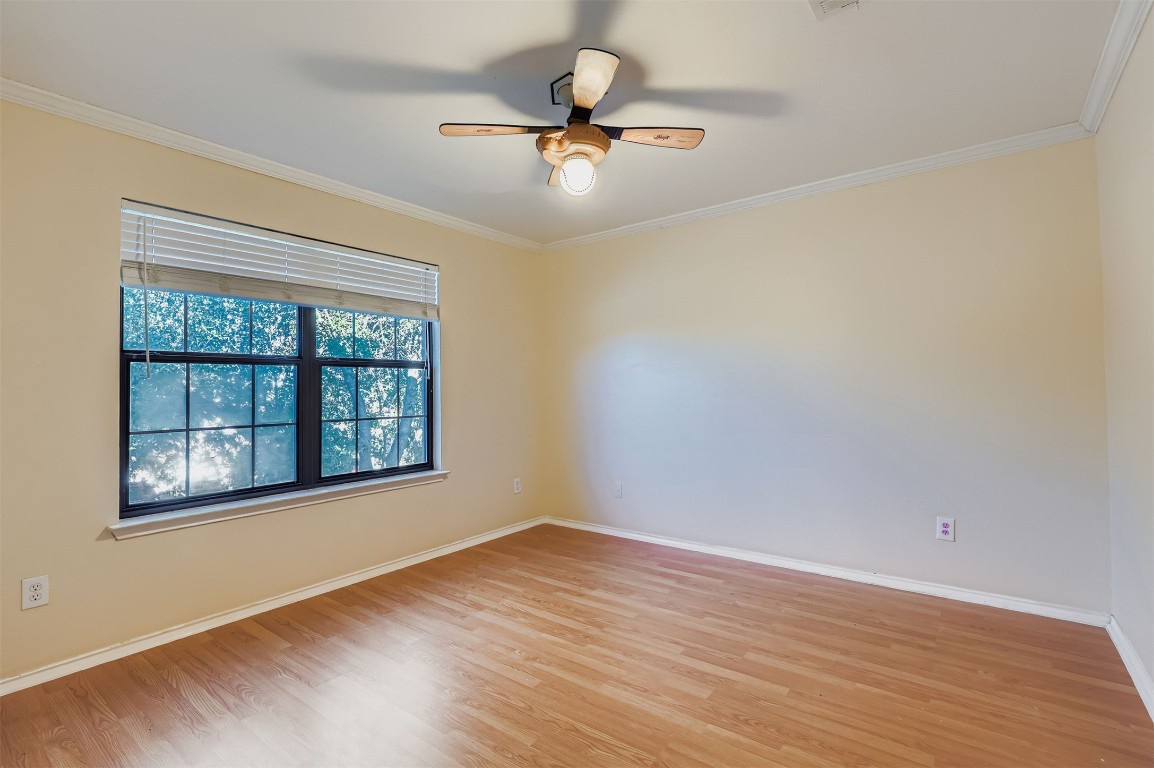 1105 American Robin Path Pflugerville, TX 78660 - Photo 23 of 32 a view of an empty room with wooden floor and a window