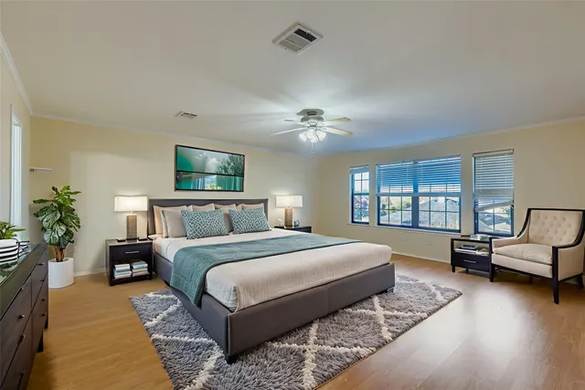 a bedroom with a large bed and a chandelier