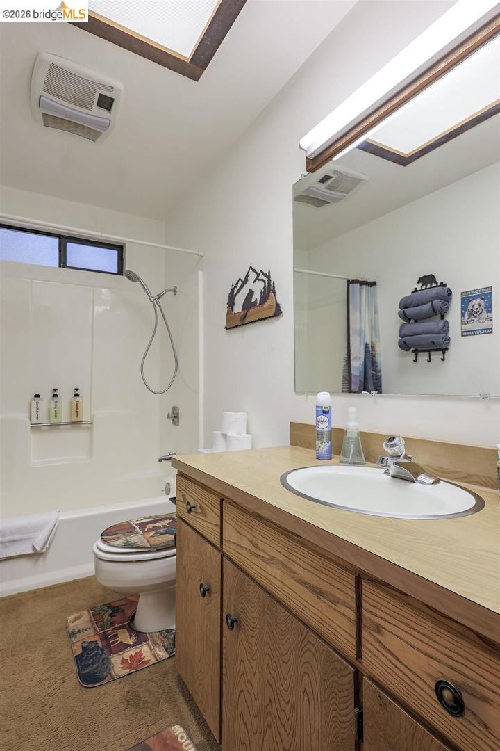 26600 Inyo Drive Cold Springs, CA 95335 - Photo 21 of 38 a bathroom with a sink toilet and a mirror