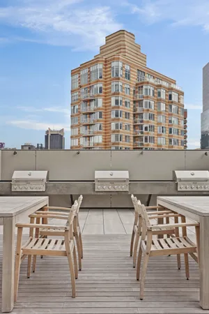 a view of dinning table and chairs on the roof deck