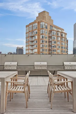 a view of dinning table and chairs on the roof deck