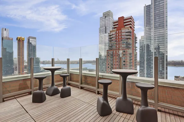 a view of roof deck with chairs and wooden floor