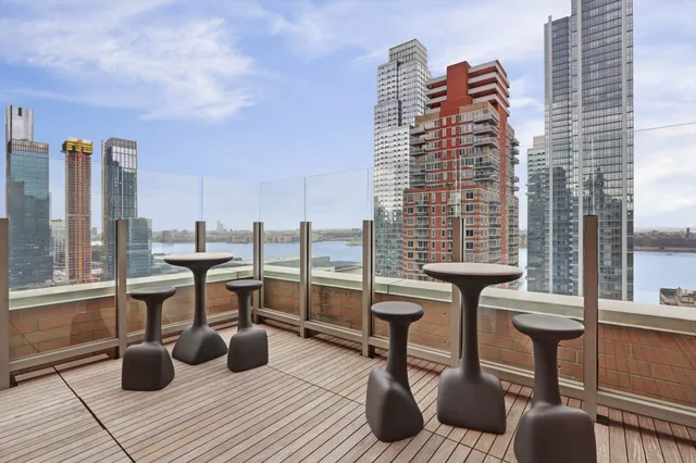 a view of roof deck with chairs and wooden floor