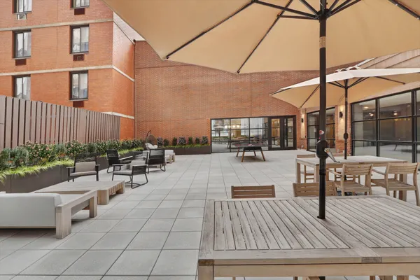 a view of a patio with couches and potted plants