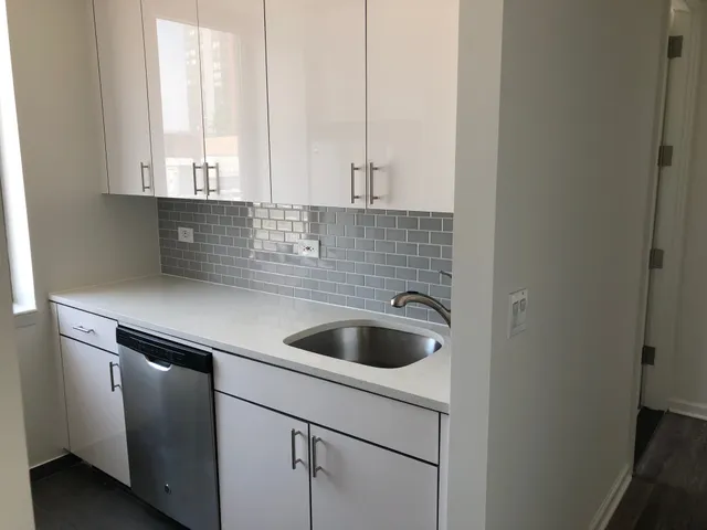 a kitchen with a sink and cabinets