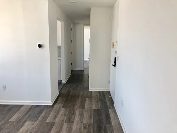 a view of a room with wooden floor and staircase