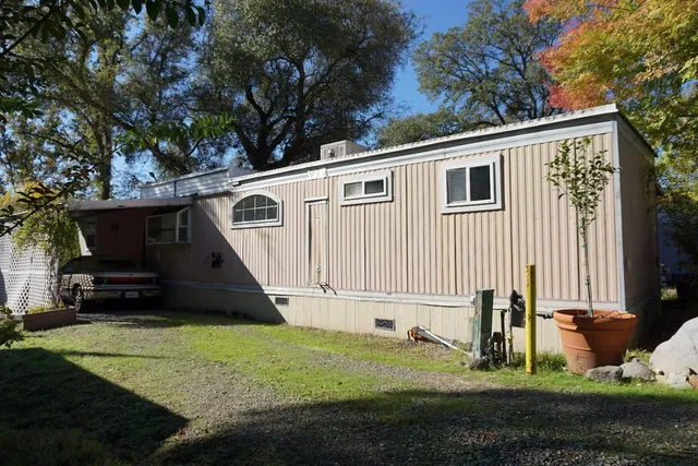 a view of a house with backyard and sitting area
