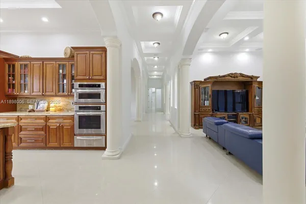 a living room with furniture and large windows
