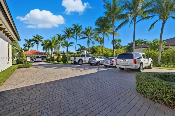 a view of a house with a swimming pool and sitting area