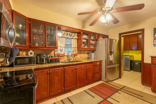 a kitchen with stainless steel appliances a stove a refrigerator and cabinets