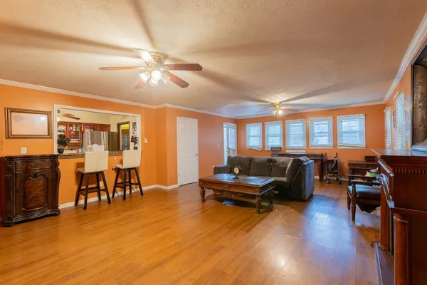 a living room with furniture and wooden floor