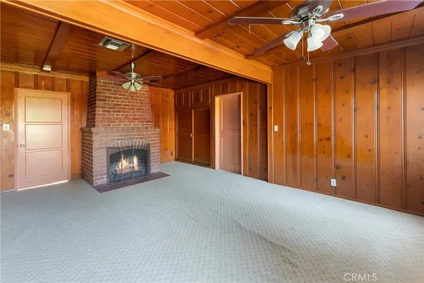 a view of empty room with a fireplace