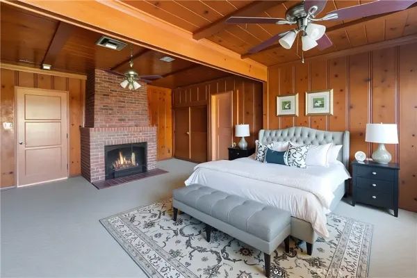 a bedroom with a bed and a fireplace