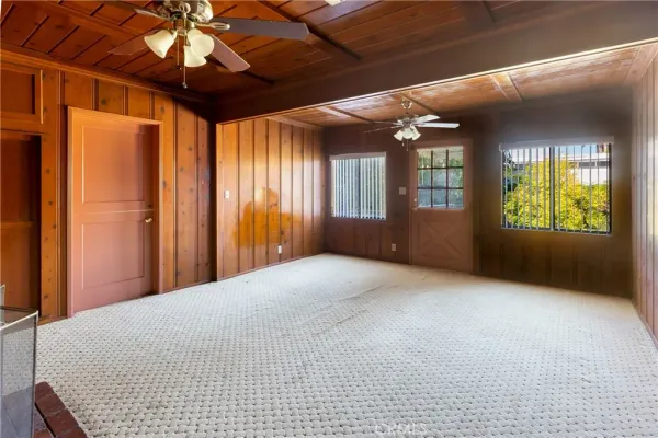 a view of an empty room with a fireplace and a window