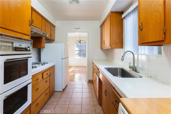 a kitchen with a sink cabinets and stainless steel appliances
