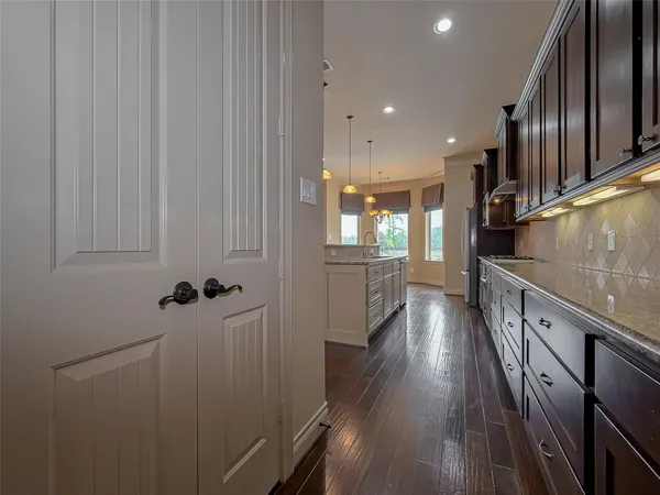 a view of a kitchen with wooden floor and electronic appliances