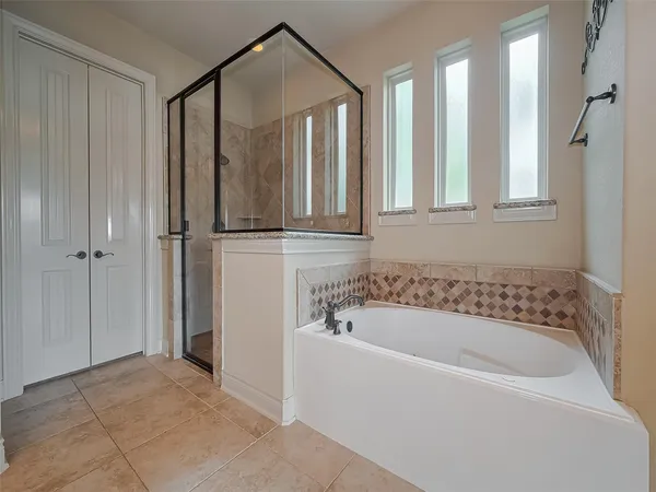 a bathroom with a bathtub and a shower