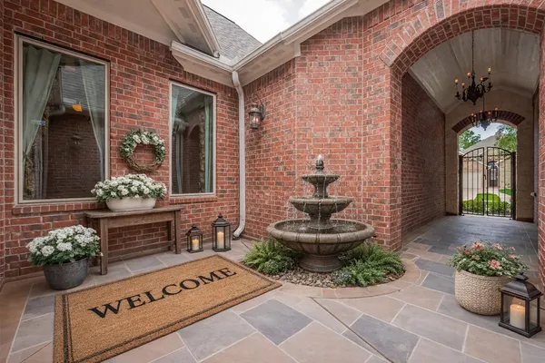 a front view of a house with potted plants