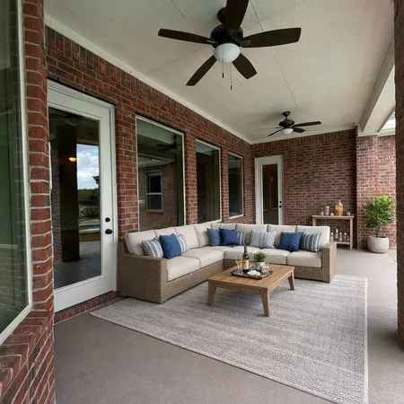a view of a patio with table and chairs