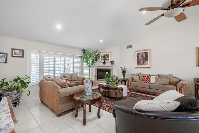 a living room with furniture potted plant and a fireplace