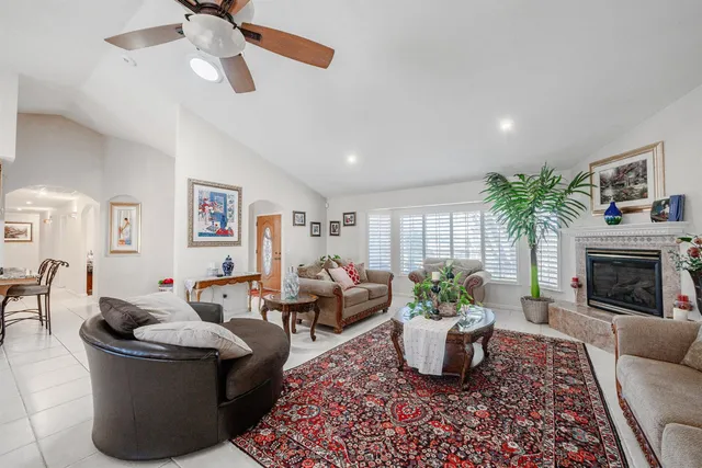 a living room with furniture ceiling fan and a rug