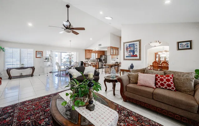 a dining room with furniture a chandelier and wooden floor