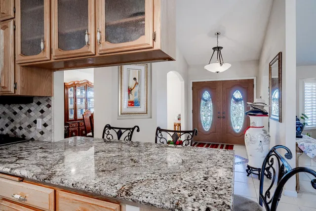 a kitchen with sink cabinets and living room view