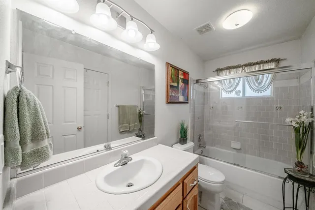 a living room with lots of furniture and kitchen view