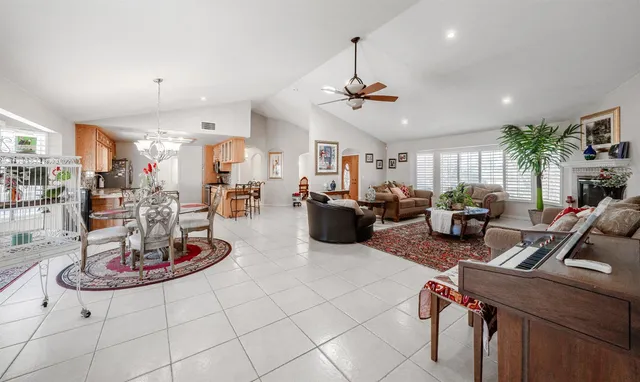 a view of a dining room with furniture and a chandelier