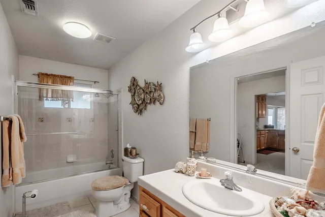 a en suite bathroom with a double vanity sink a mirror and a shower