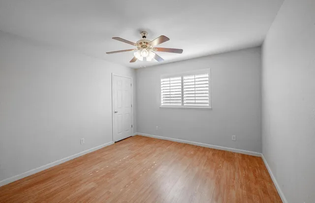 a bathroom with a bathtub a shower and a window