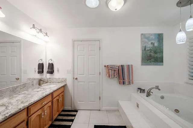 a bathroom with double sink and a mirror