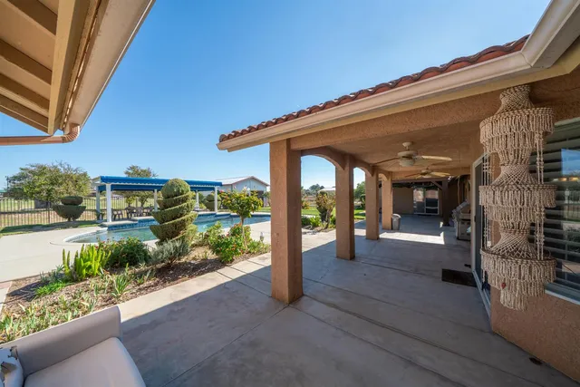 a view of a house with a yard and potted plants