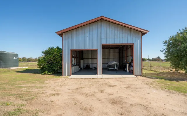 a view of a house with a yard and garage