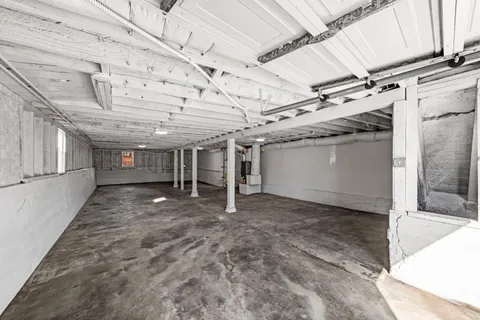 a view of backyard with large trees and wooden fence